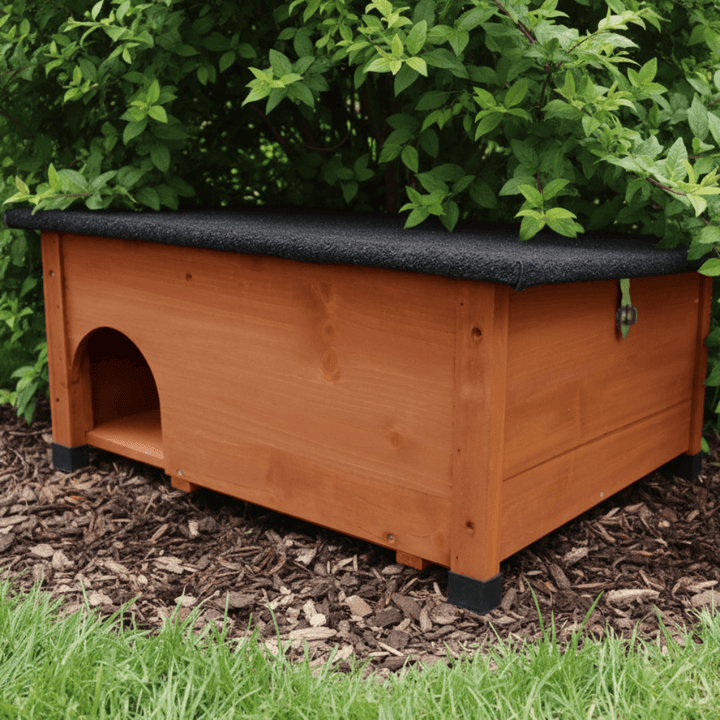 A wooden hedgehog house under a bush