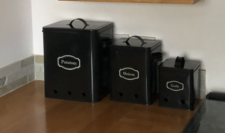 Kitchen storage tins stood on a worktop