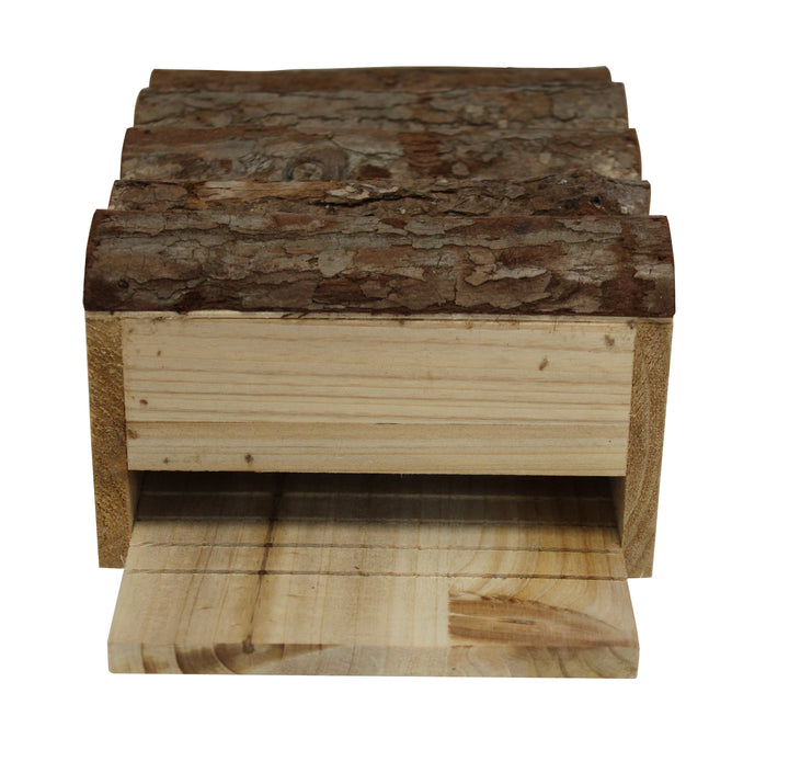 A wooden bat house with a natural wood finish and a metal entrance slit, designed to resemble a bark-like texture.