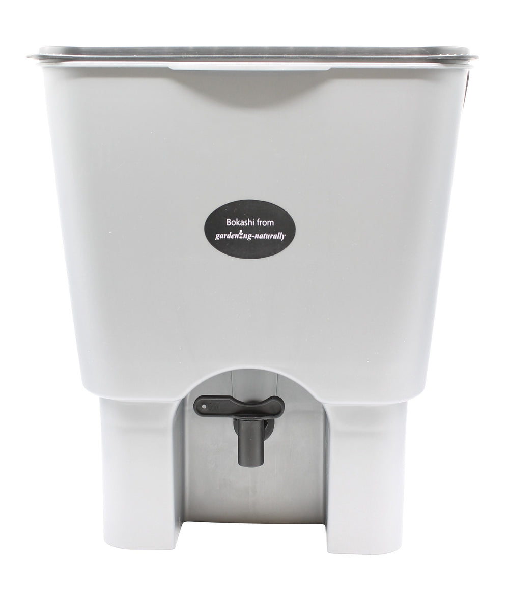 A single bokashi bin with tap on a white background