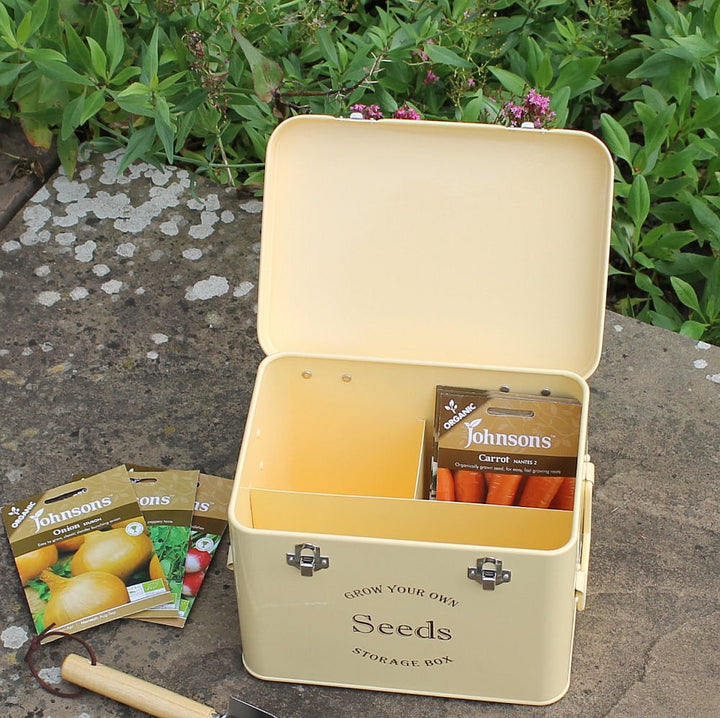 Seed storage tin, cream shown with lid open and seeds inside