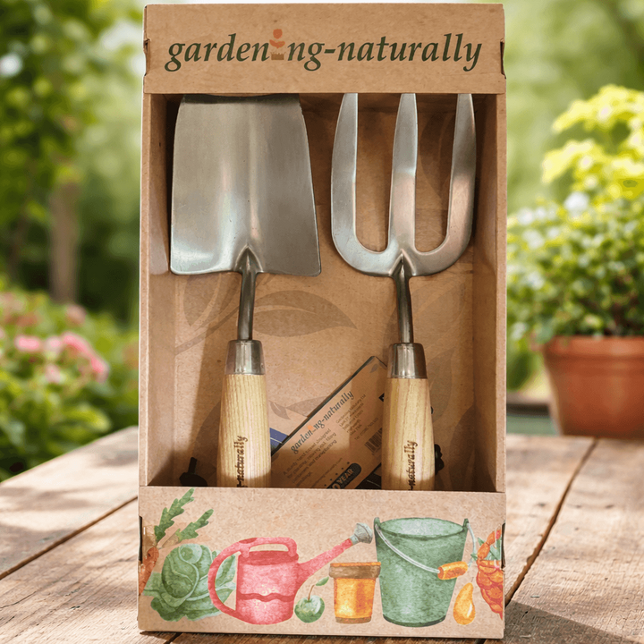 A boxed gardening tool set displayed in an open kraft paper package on a wooden table.