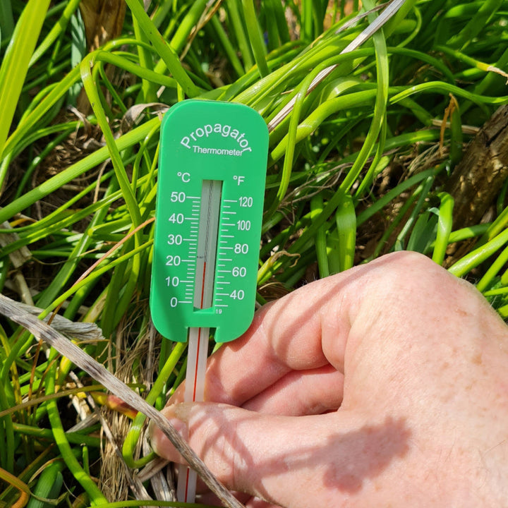 A green plastic thermometer labelled 'Propagator Thermometer'