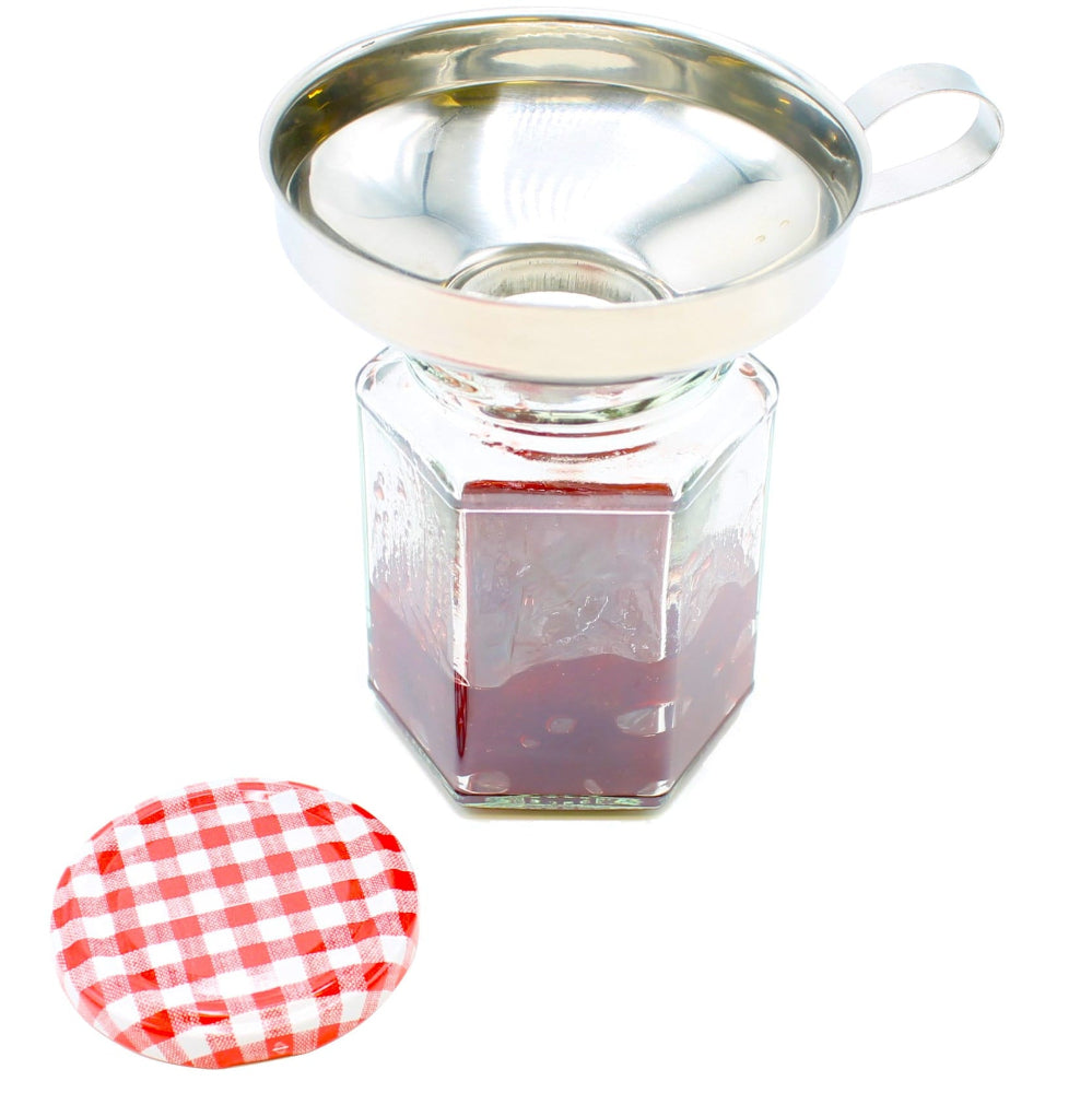 a jam jar with a funnel with strawberry jam