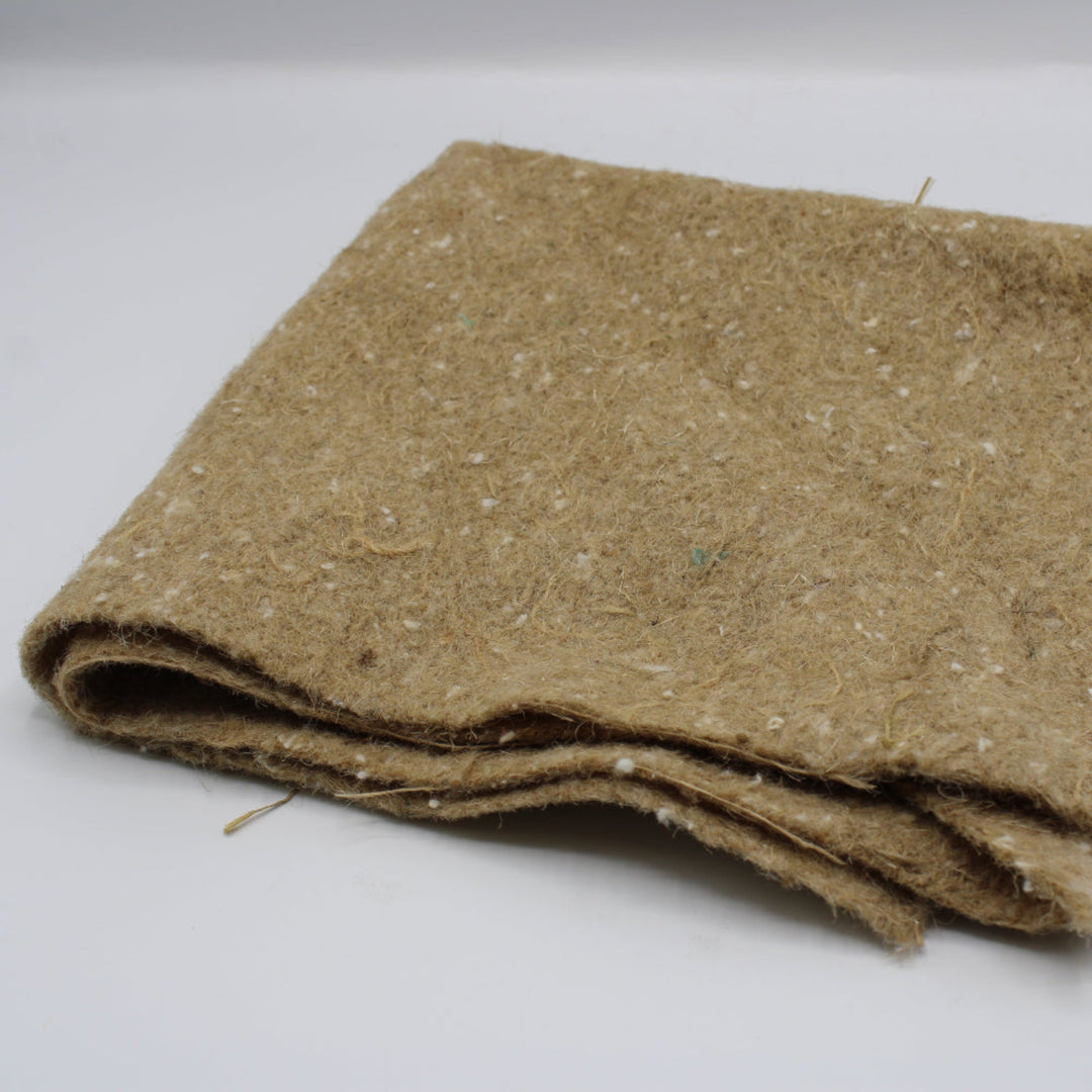 A folded piece of brown weed fabric with a textured, fibrous surface.