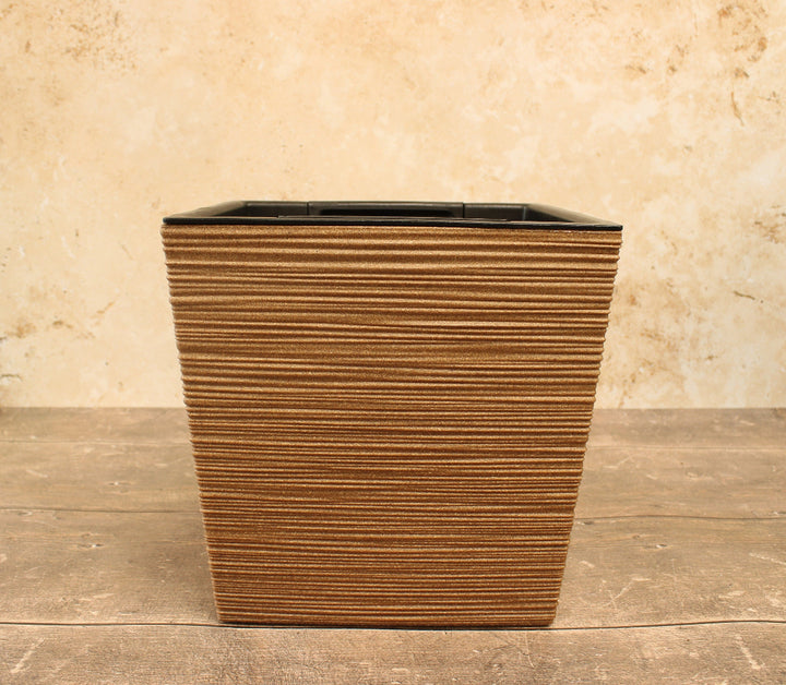 Natural garden plant pot on wooden base with cream background