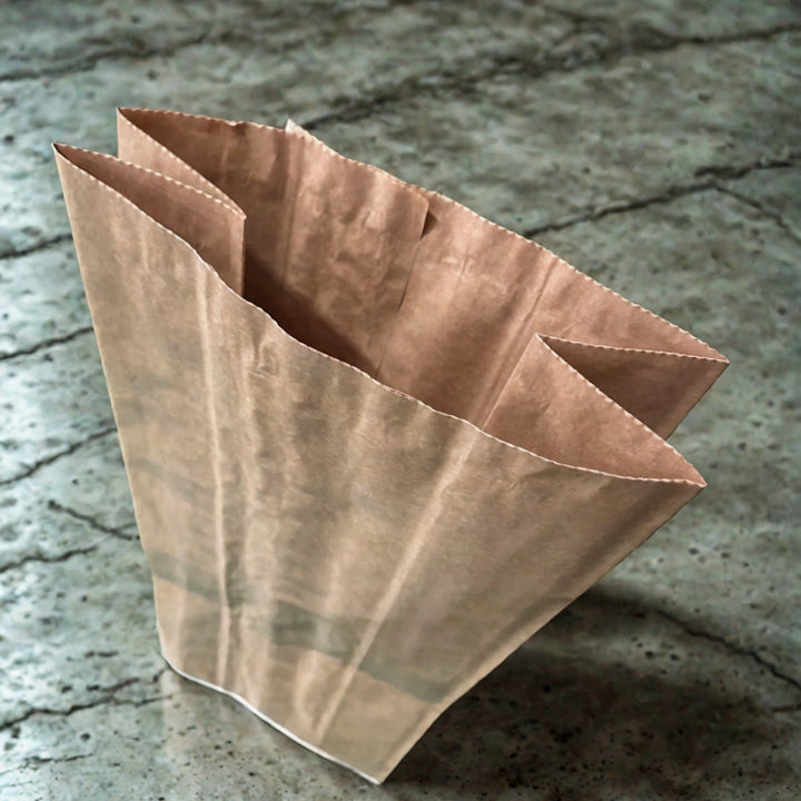 Paper potato sack stood on concrete floor