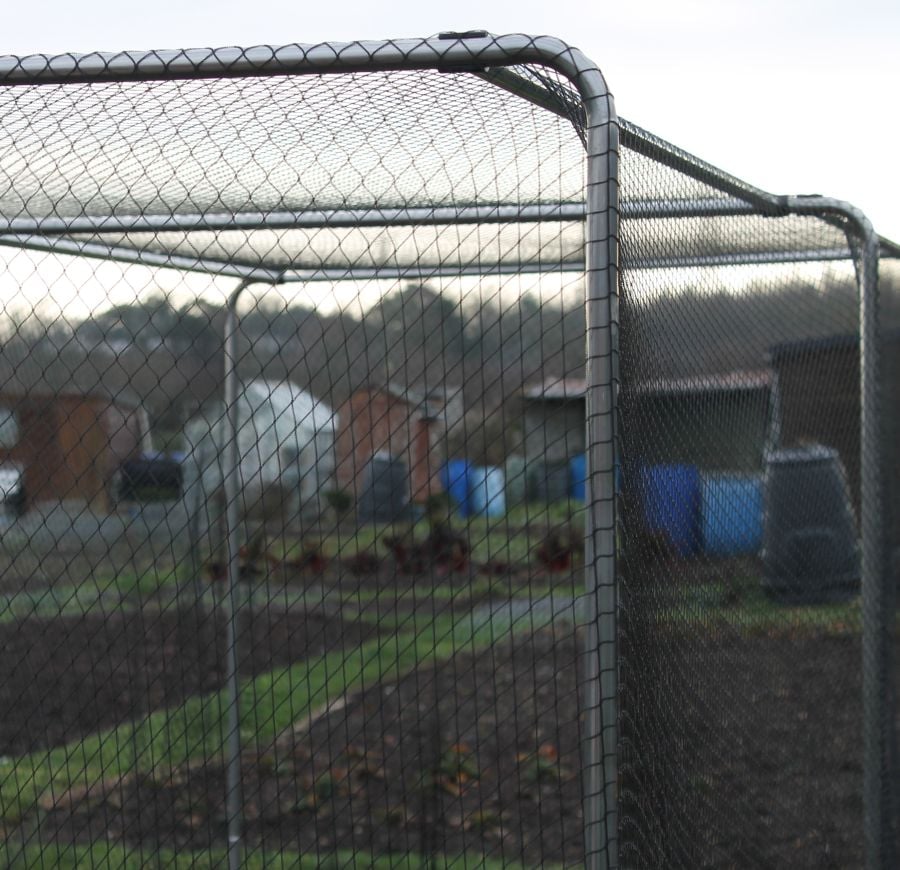 Chain-link fence with a view of a residential area through it